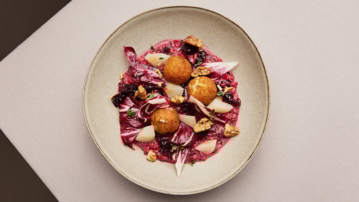 Radicchio risotto with cheese pralines and espuma