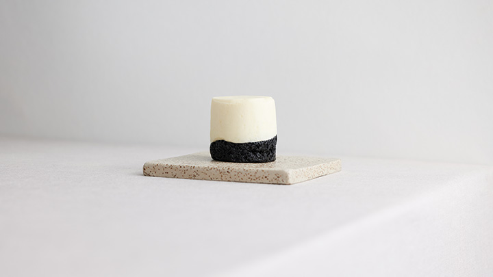 Black tahini financier with white chocolate mousse and pear compote