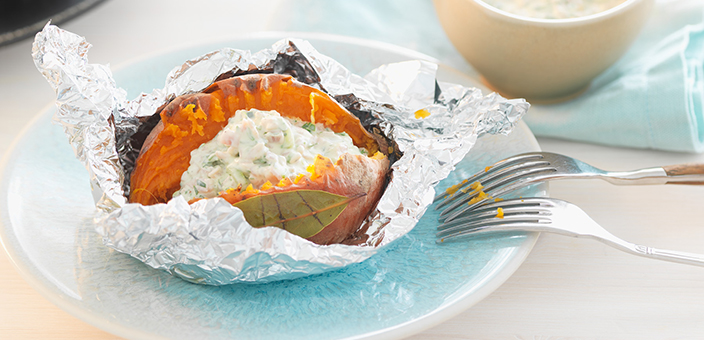 Sweet potatoes baked in aluminium foil and served with a ham and sour cream sauce